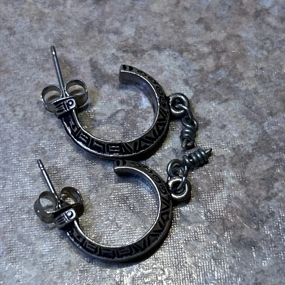 Vintage artisan-style silver hoop earrings (unmarked) with etched geo design